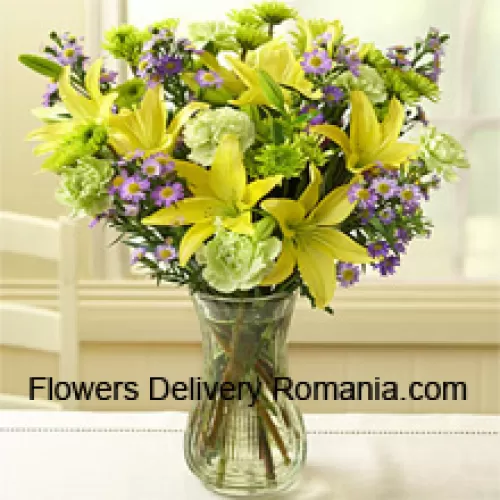 Yellow Lilies And Other Assorted Flowers Arranged Beautifully In A Glass Vase