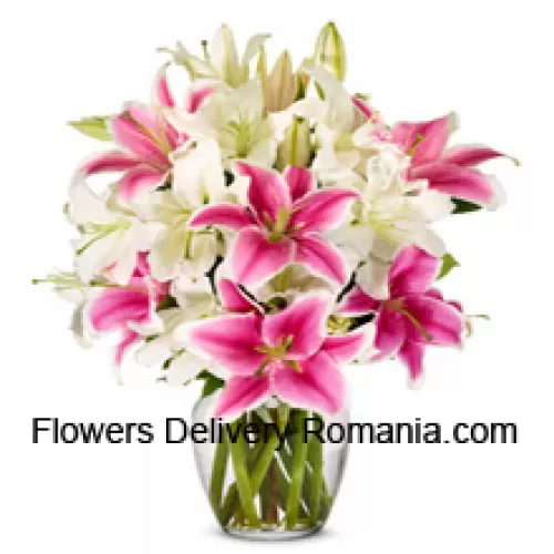 White And Pink Lilies With Some Ferns In A Glass Vase
